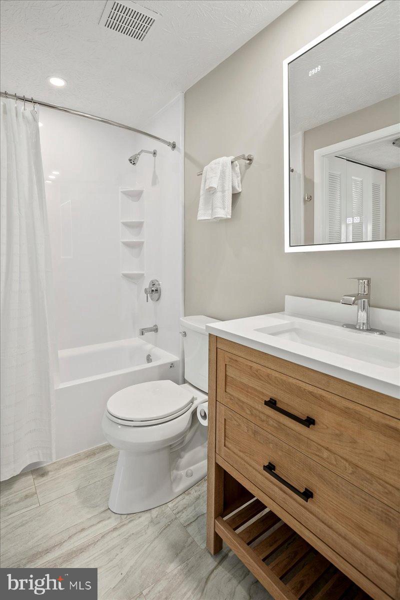 1642 Harvest Green Court Reston, VA 20194 - Photo 26 of 46 a bathroom with a sink a toilet and shower
