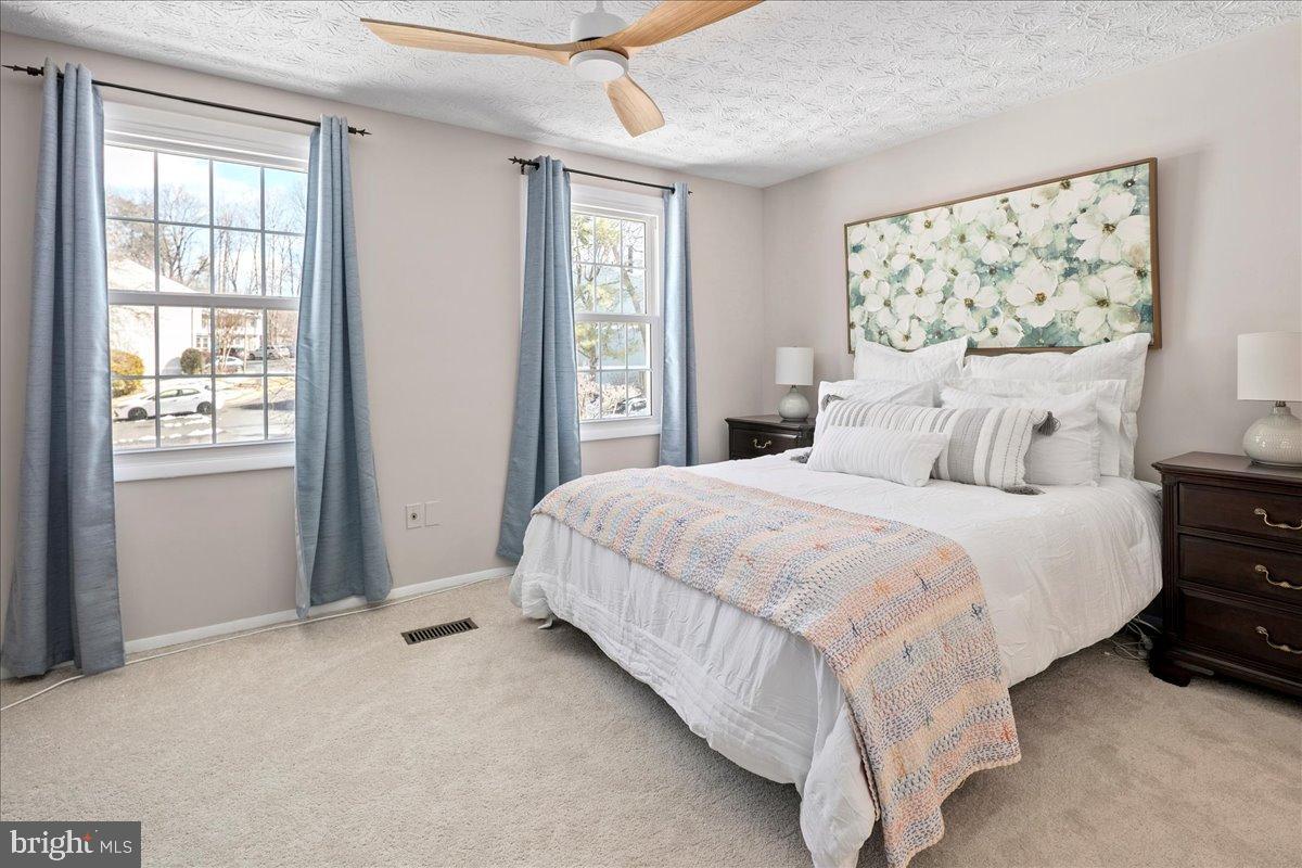 1642 Harvest Green Court Reston, VA 20194 - Photo 27 of 46 a bedroom with a large bed and a window