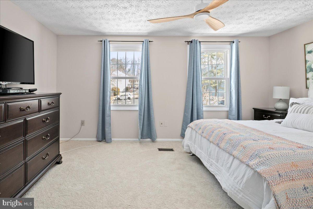 1642 Harvest Green Court Reston, VA 20194 - Photo 28 of 46 a bedroom with a bed and a flat screen tv