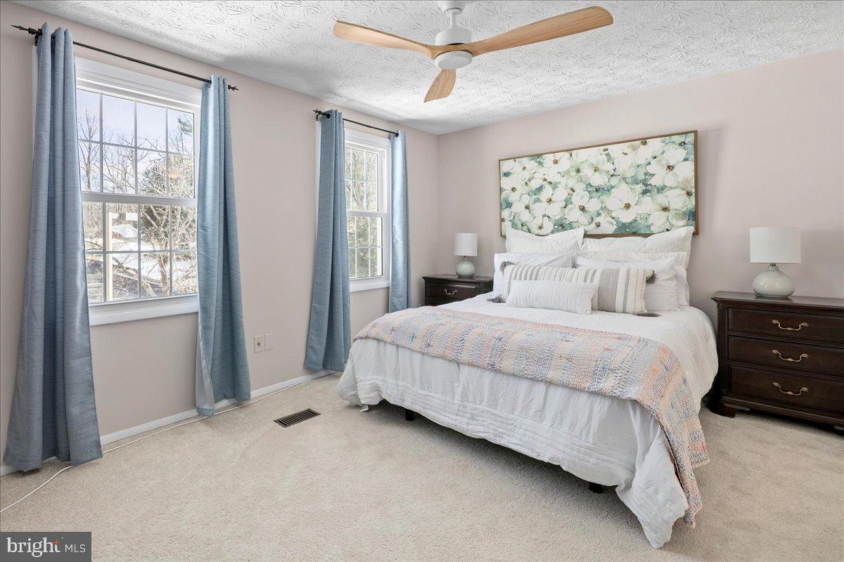 1642 Harvest Green Court Reston, VA 20194 - Photo 29 of 46 a bedroom with a large bed and a window