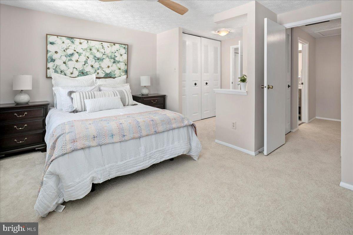 1642 Harvest Green Court Reston, VA 20194 - Photo 30 of 46 a bedroom with a bed and a painting on the wall