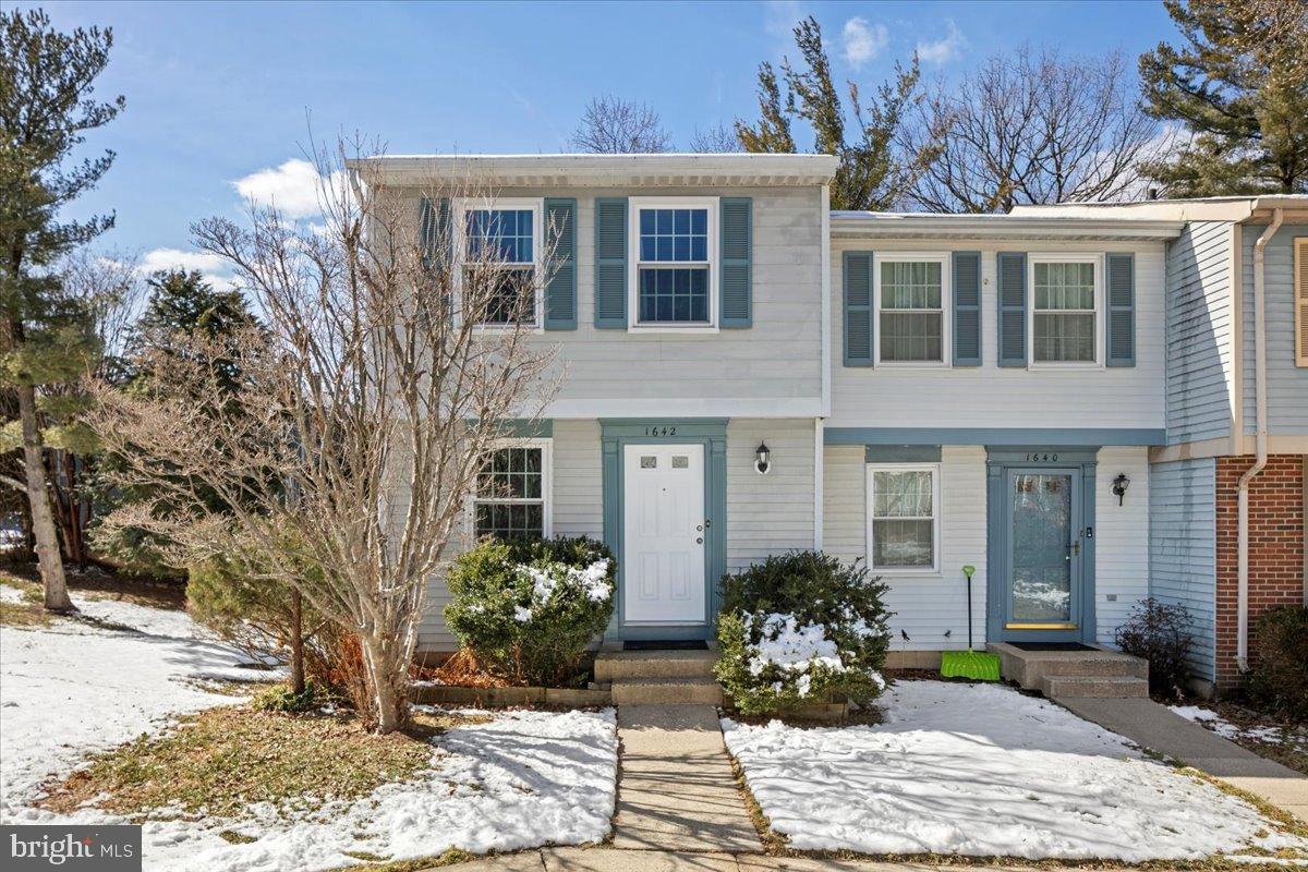 1642 Harvest Green Court Reston, VA 20194 - Photo 3 of 46 a view of a brick house with large windows