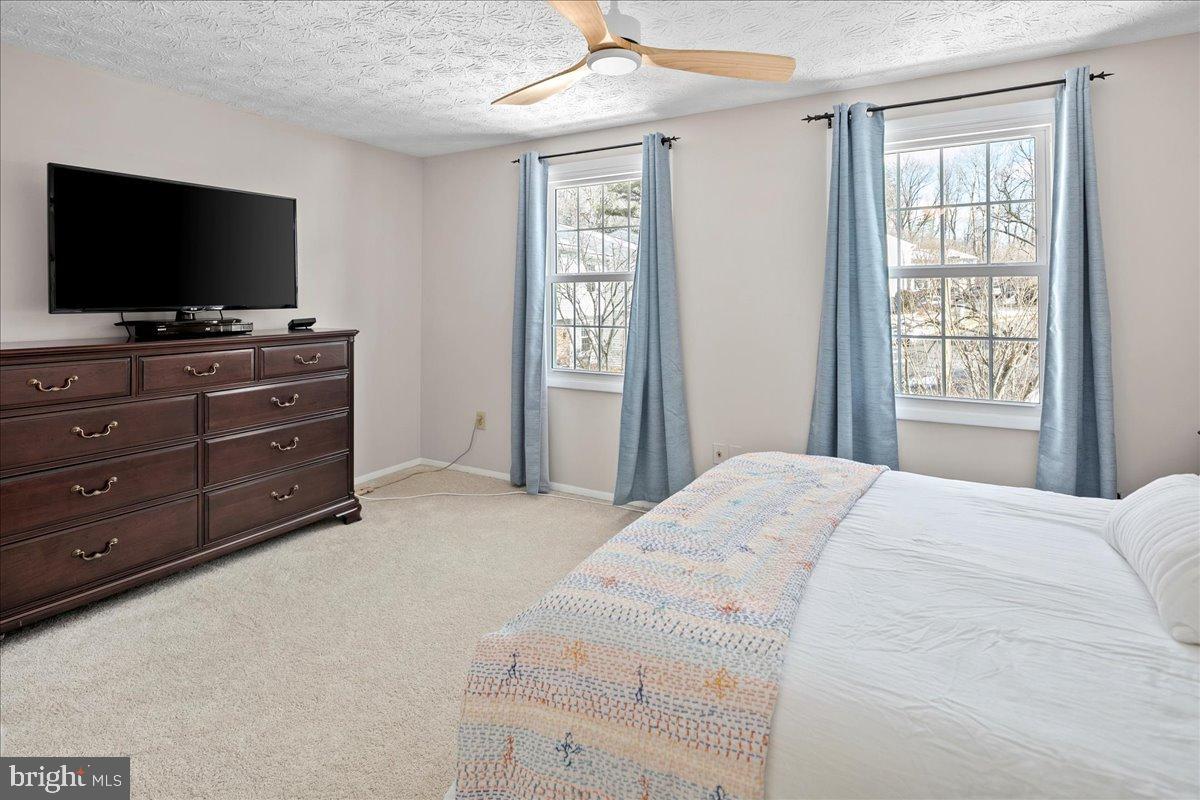 1642 Harvest Green Court Reston, VA 20194 - Photo 31 of 46 a bedroom with a bed and a flat screen tv