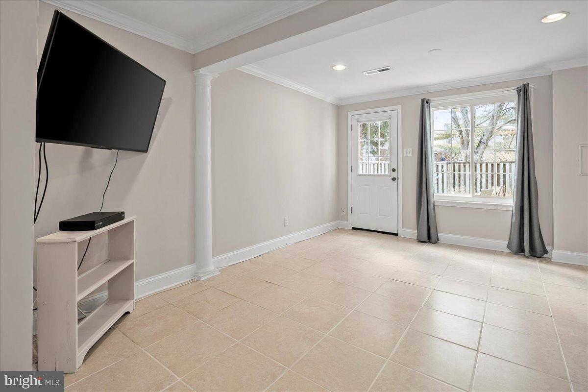 1642 Harvest Green Court Reston, VA 20194 - Photo 34 of 46 a view of an empty room with a fireplace and a window