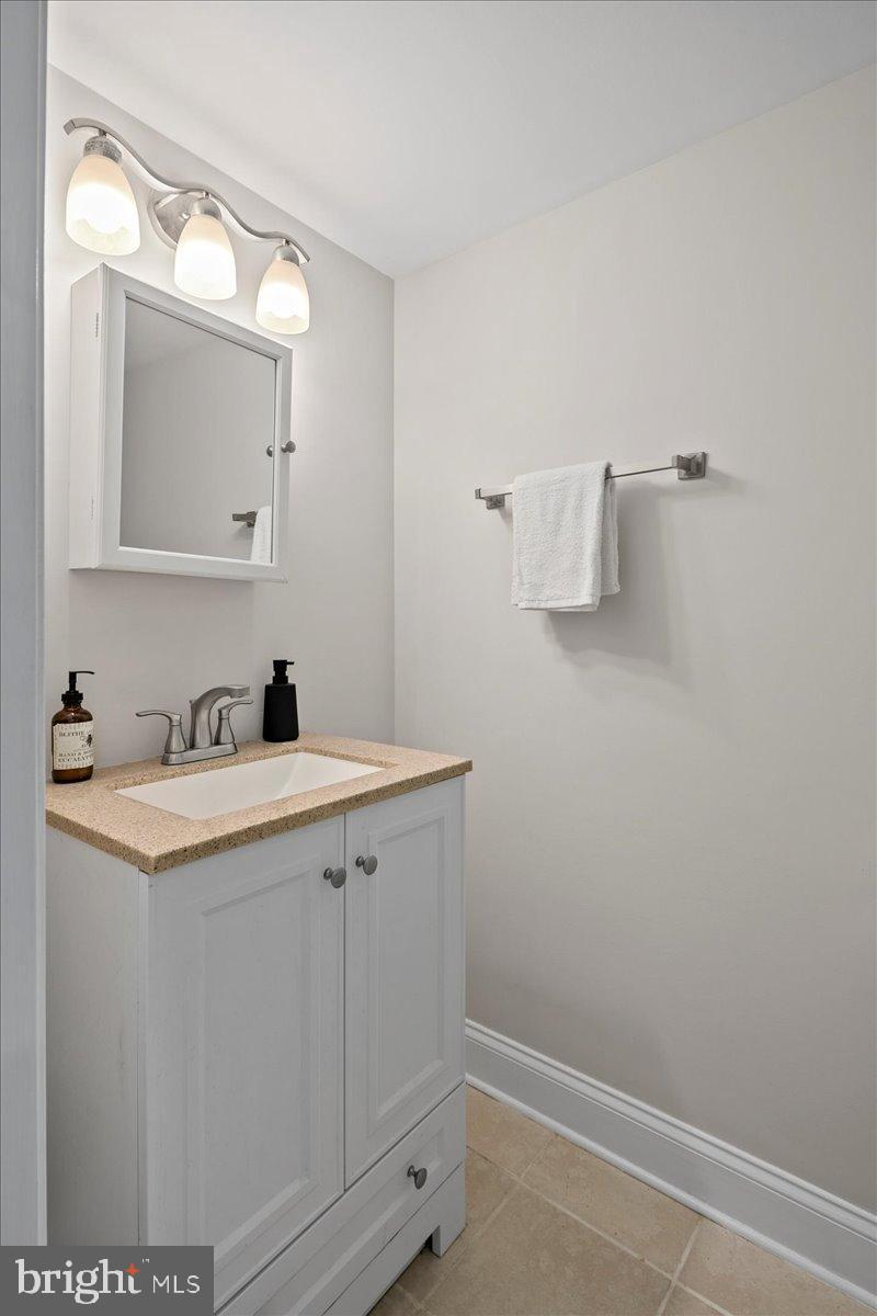 1642 Harvest Green Court Reston, VA 20194 - Photo 38 of 46 a view of a bathroom with a sink and mirror