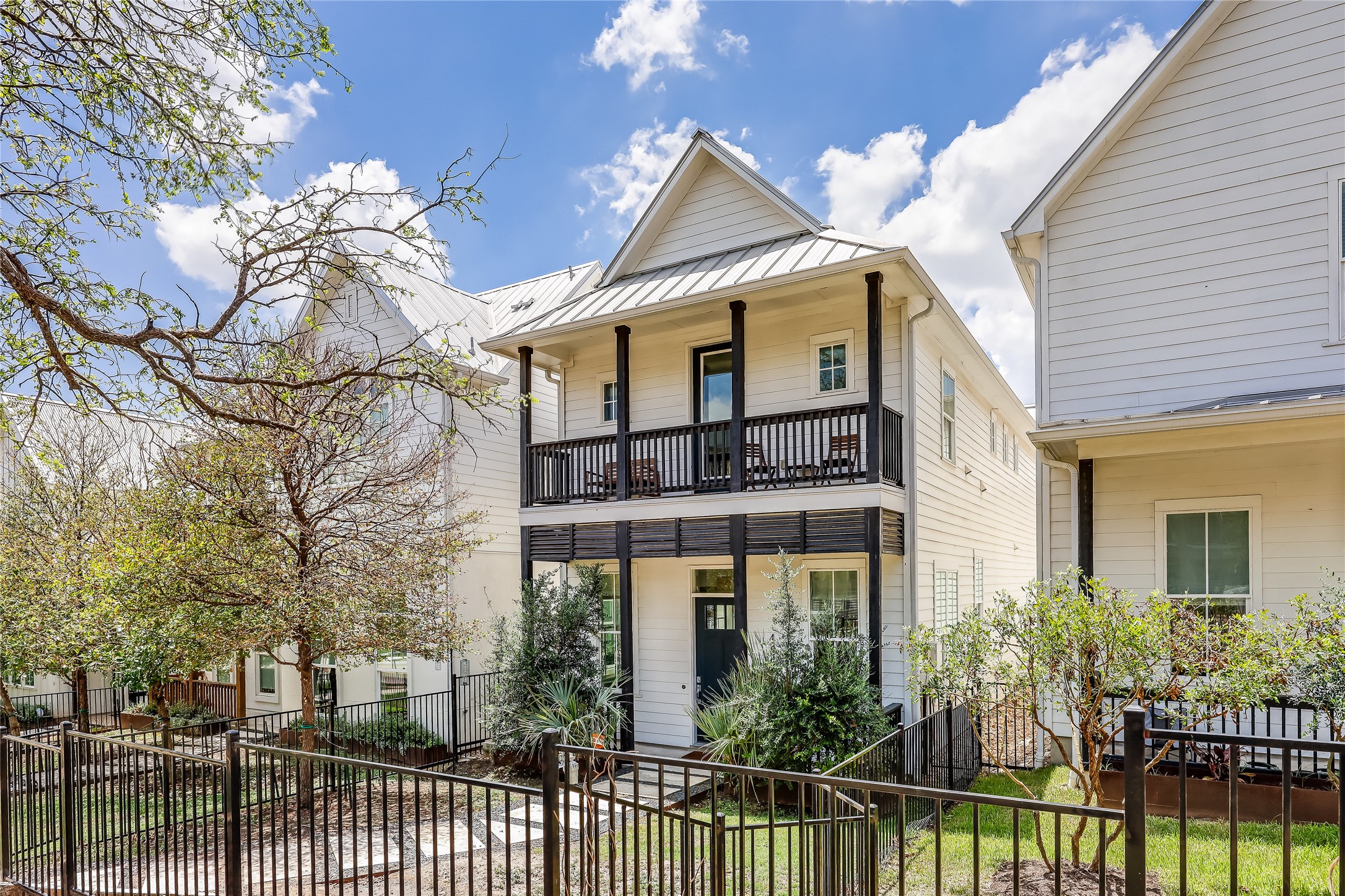 4808 Springdale Road Austin, TX 78723 - Photo 1 of 1 View of front facade featuring a balcony, a fenced front yard, and a porch