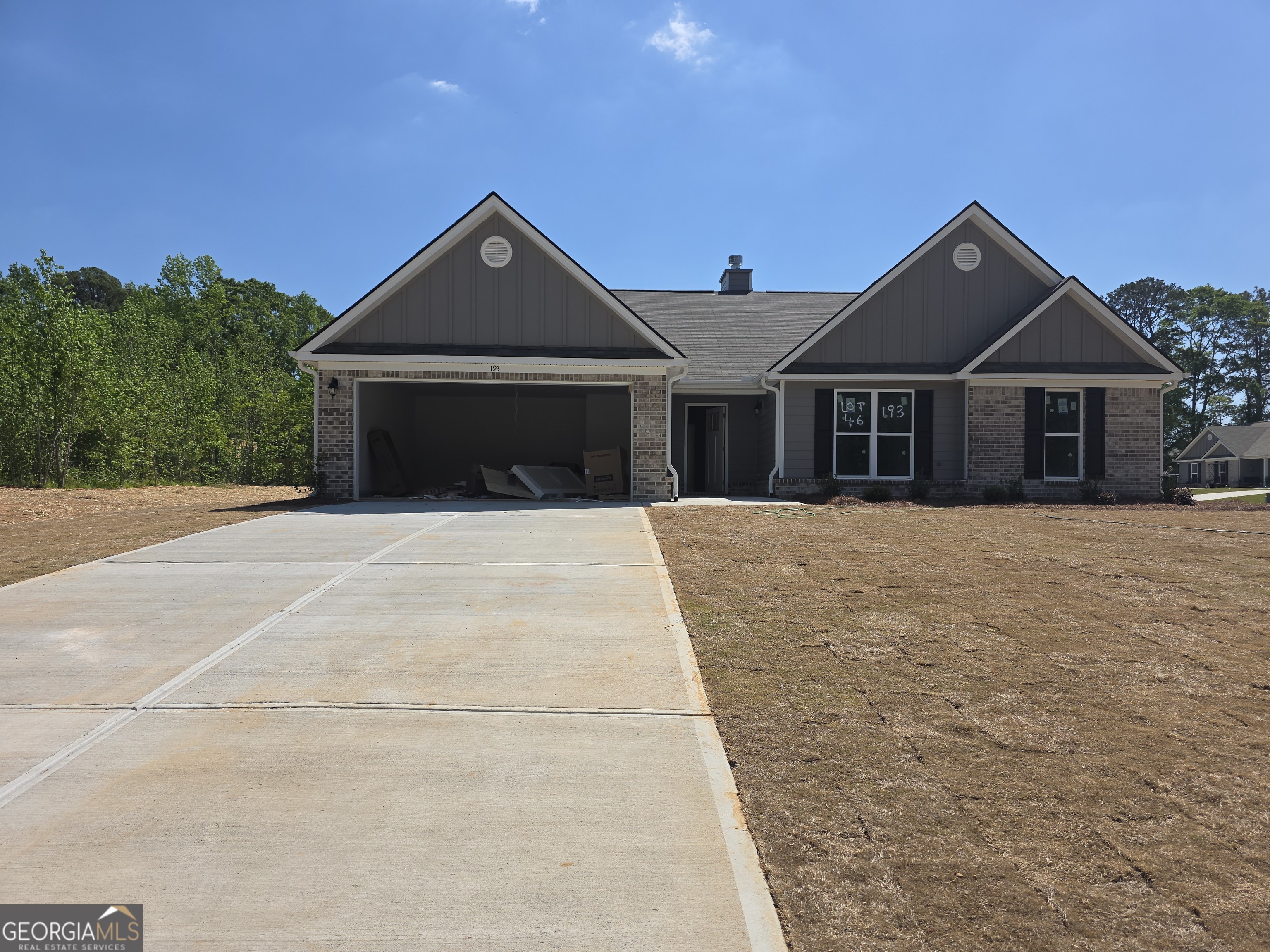 193 Windrow Trail, Unit 46 Statham, GA 30666 - Photo 3 of 5 a front view of a house with a yard and garage