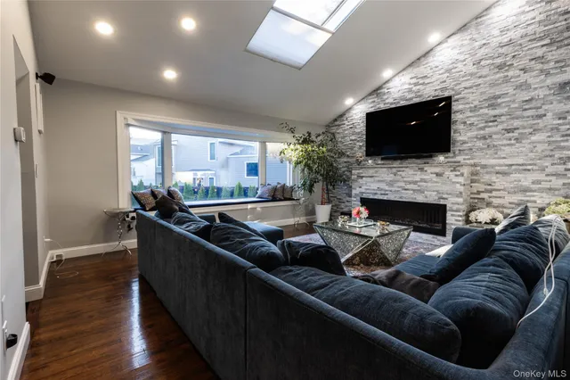 a living room with furniture a flat screen tv and a fireplace