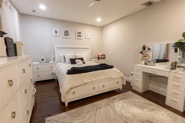 a room with a bed and a view of kitchen