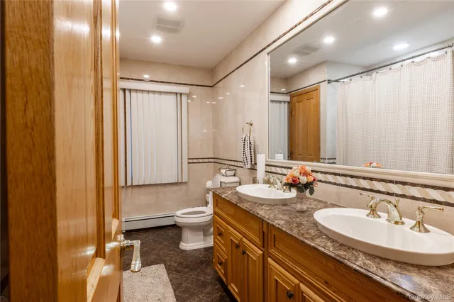 a bathroom with a double vanity sink and a mirror