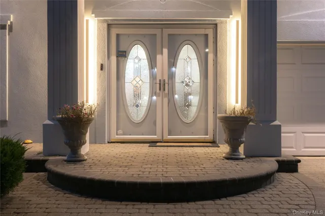 a view of a door of the house with potted plant