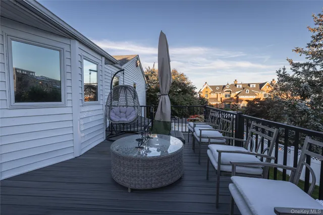 a view of a chair and tables in the balcony