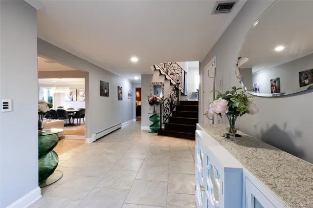 a kitchen with stainless steel appliances granite countertop a sink a stove top oven a chimney and a counter top space