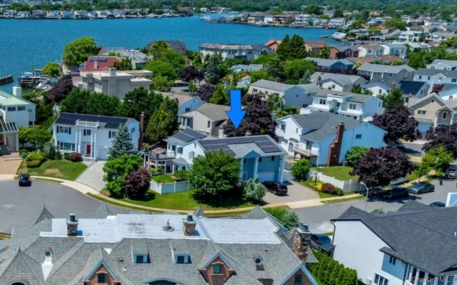 an aerial view of a house with a lake view