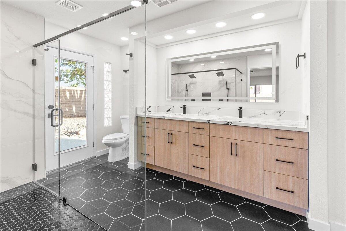 3190 East Vincentia Road Palm Springs, CA 92262 - Photo 23 of 30 a spacious bathroom with a double vanity sink mirror and toilet
