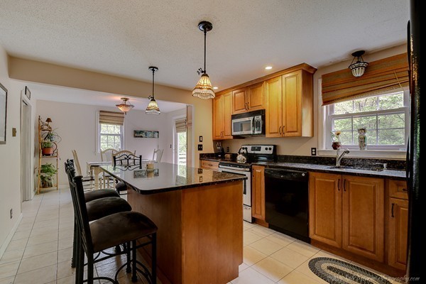 37 Tenney Road Rowley, MA 01969 - Photo 3 of 20 a kitchen with granite countertop sink stove and refrigerator