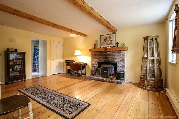 37 Tenney Road Rowley, MA 01969 - Photo 6 of 20 a room with patio fireplace and a dining table with wooden floor