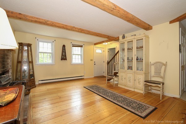 37 Tenney Road Rowley, MA 01969 - Photo 8 of 20 a living room with a couch a rug and a flat screen tv