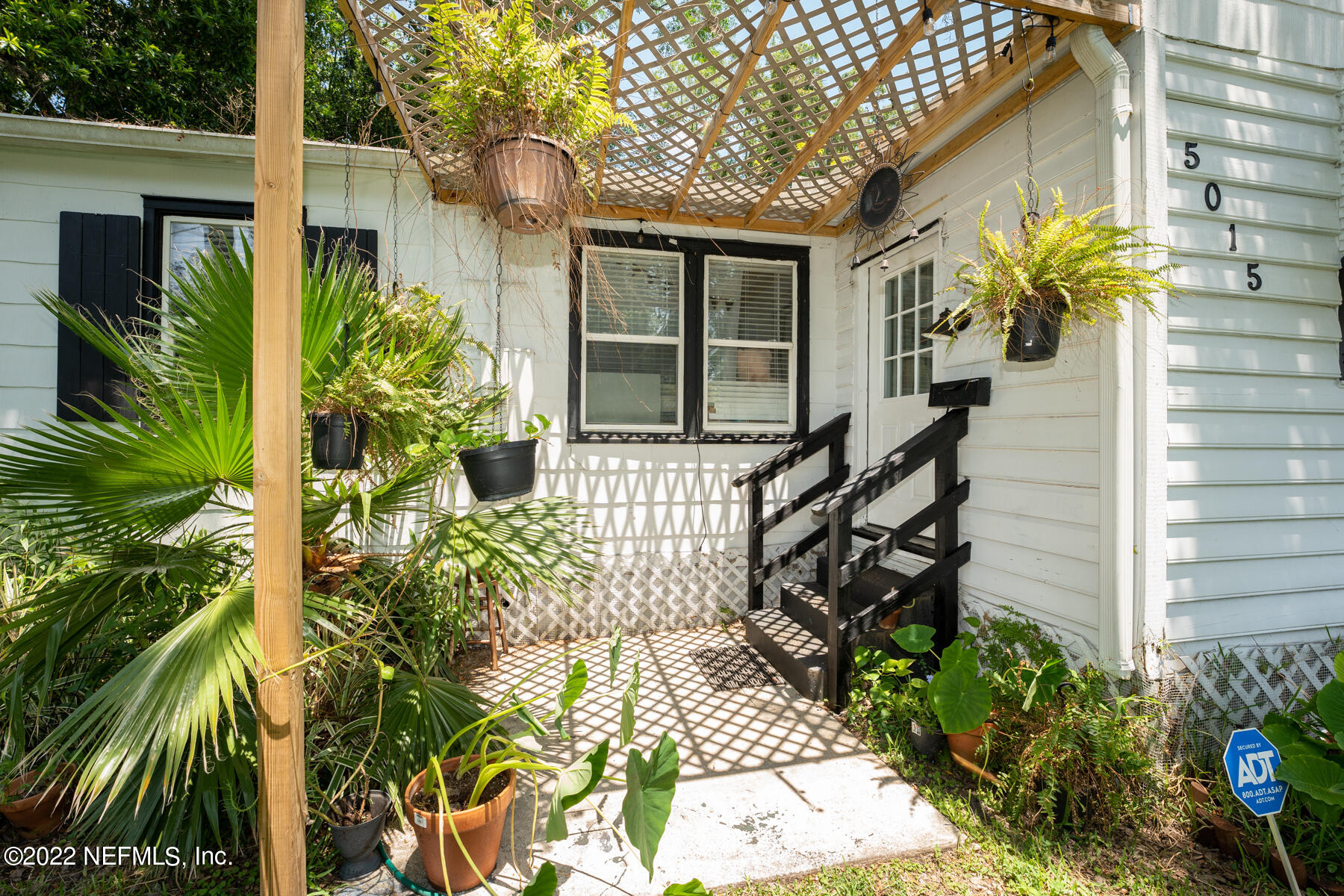 5015 Birkenhead Road Jacksonville, FL 32210 - Photo 2 of 17 a front view of a house with a garden