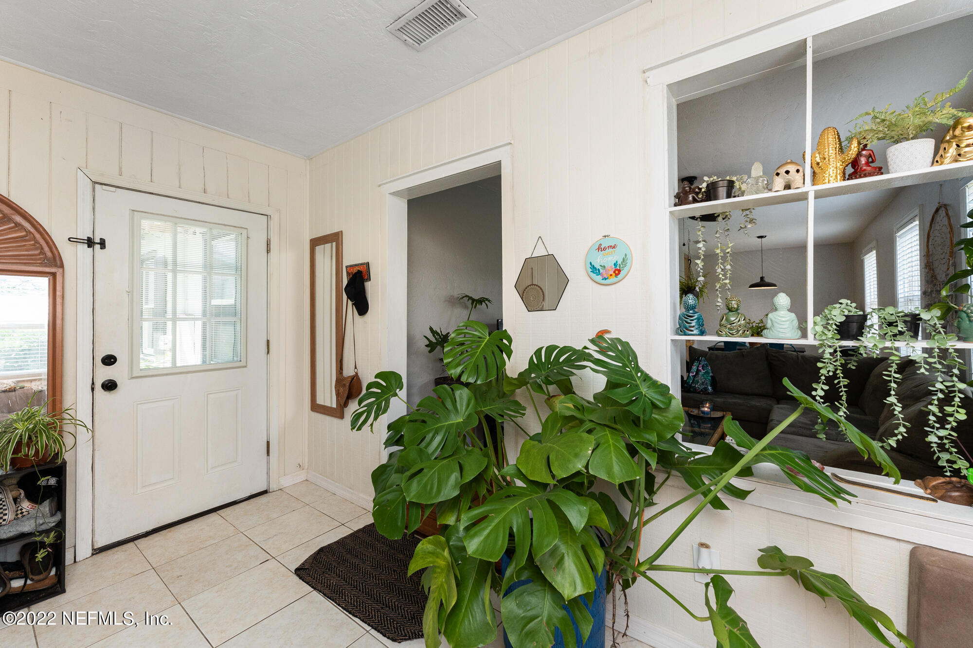 5015 Birkenhead Road Jacksonville, FL 32210 - Photo 3 of 17 a living room with furniture and a potted plant