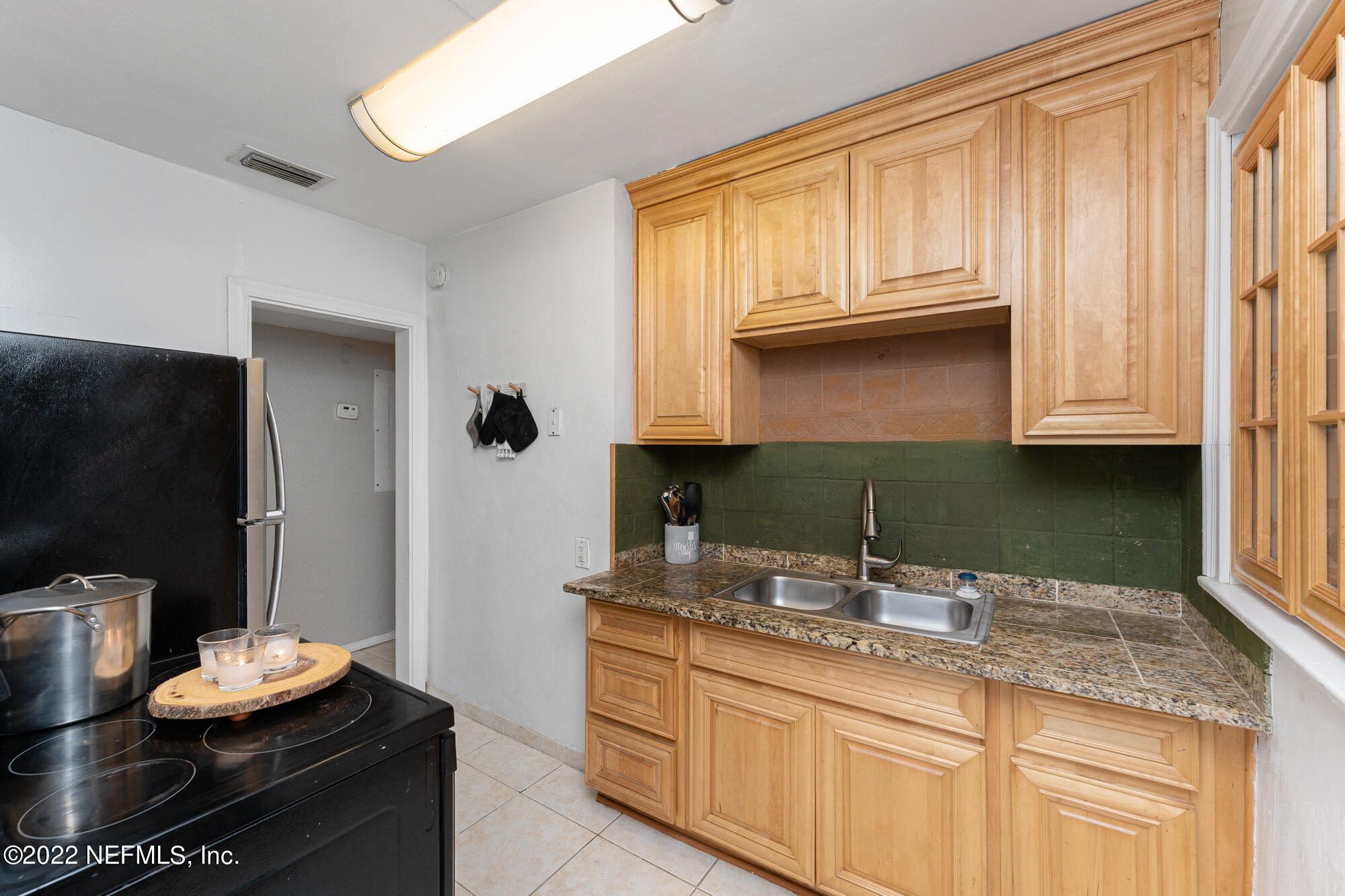 5015 Birkenhead Road Jacksonville, FL 32210 - Photo 8 of 17 a kitchen with stainless steel appliances granite countertop a sink and cabinets