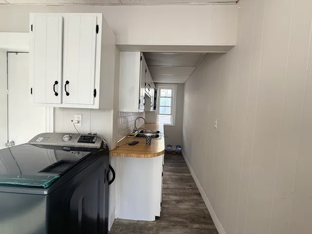 a kitchen with a sink a stove and cabinets