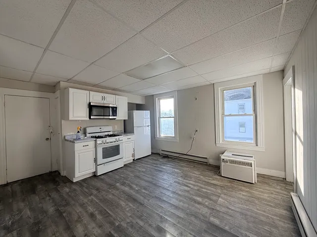 a view of kitchen with microwave oven stove and oven