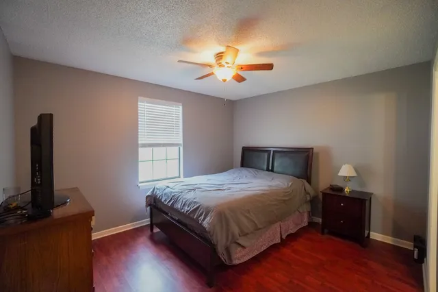 a bedroom with a bed and a television