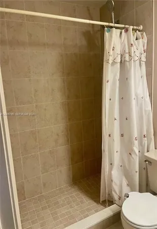a bathroom with a shower and a toilet