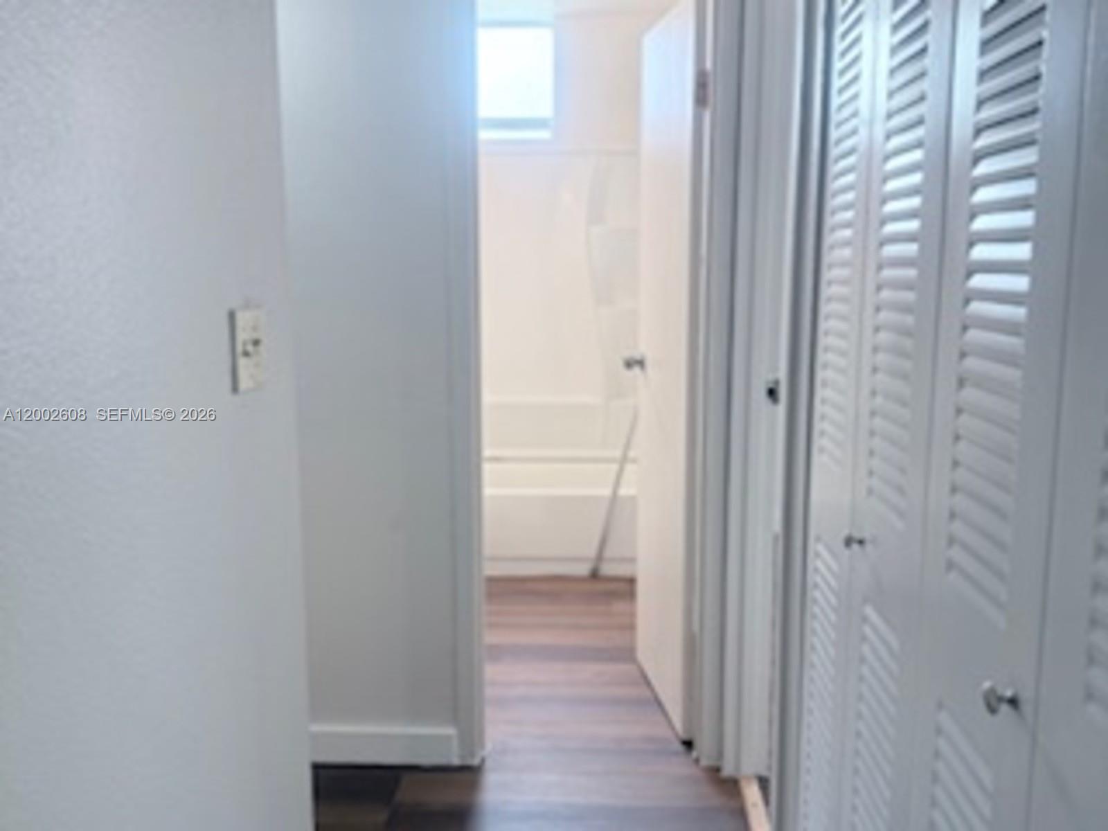 5966 Southwest 68th Street, Unit 109 Miami, FL 33143 - Photo 6 of 12 a view of a bathroom from the hallway
