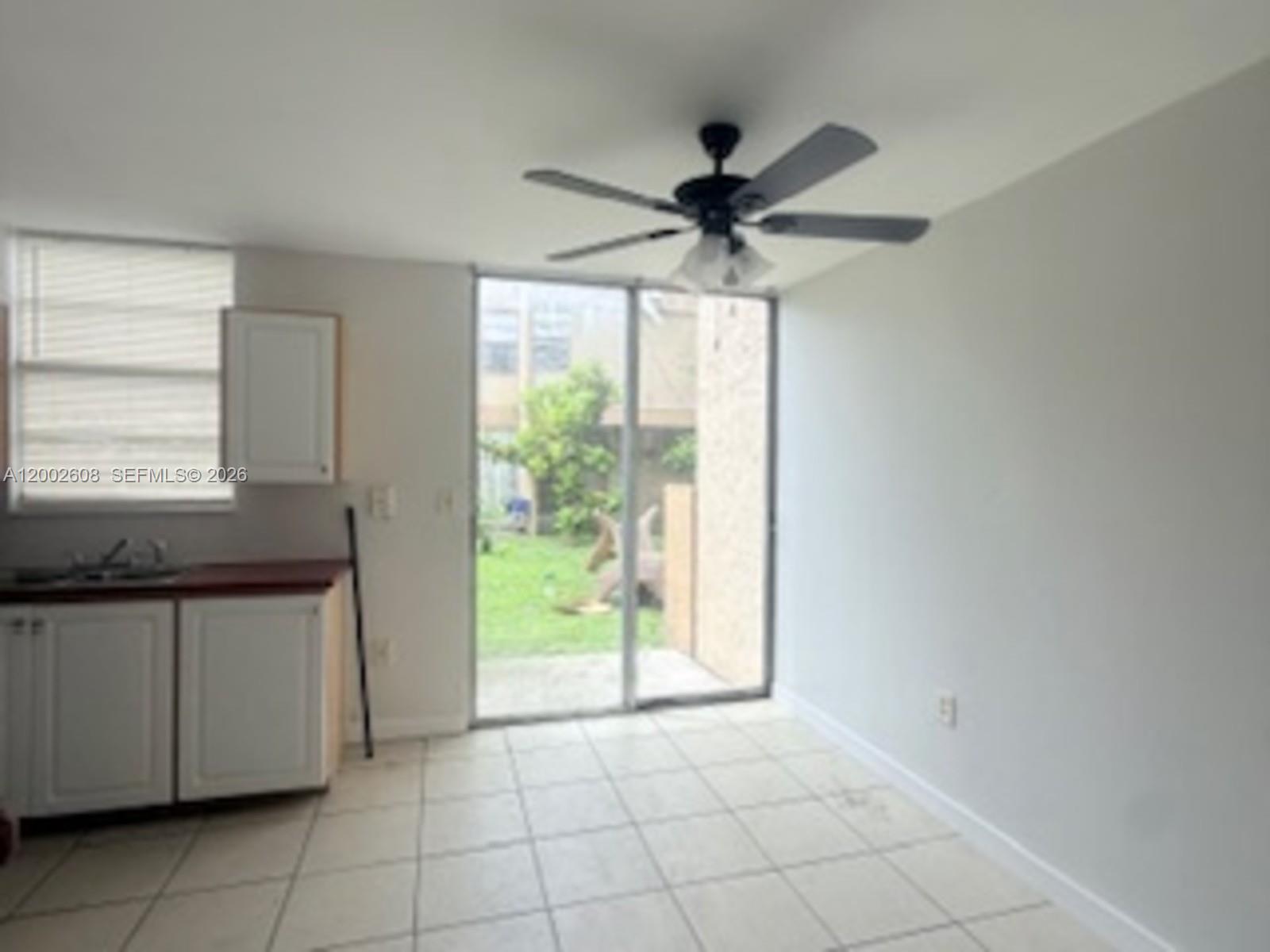 5966 Southwest 68th Street, Unit 109 Miami, FL 33143 - Photo 10 of 12 a kitchen with granite countertop a stove a sink and a refrigerator
