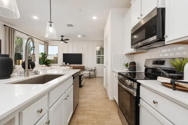 a large kitchen with a large counter top appliances and cabinets