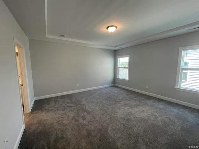 an empty room with windows and entrance