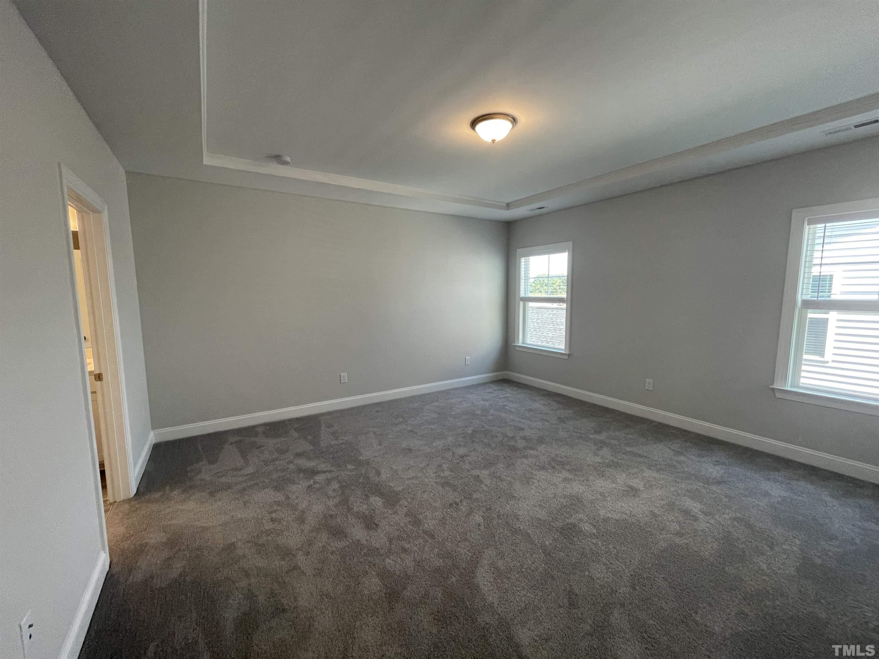 167 Edge Of Auburn Boulevard Clayton, NC 27520 - Photo 15 of 27 an empty room with windows