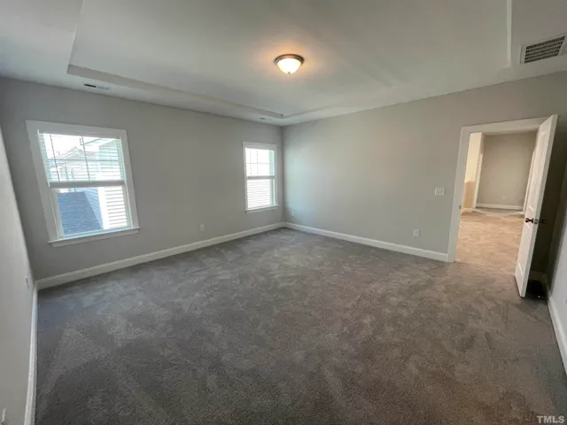 a spacious bathroom with a double vanity sink and mirror