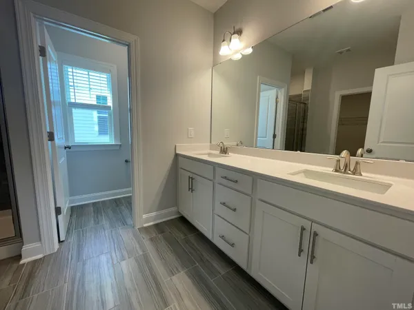 a bathroom with a shower and a sink