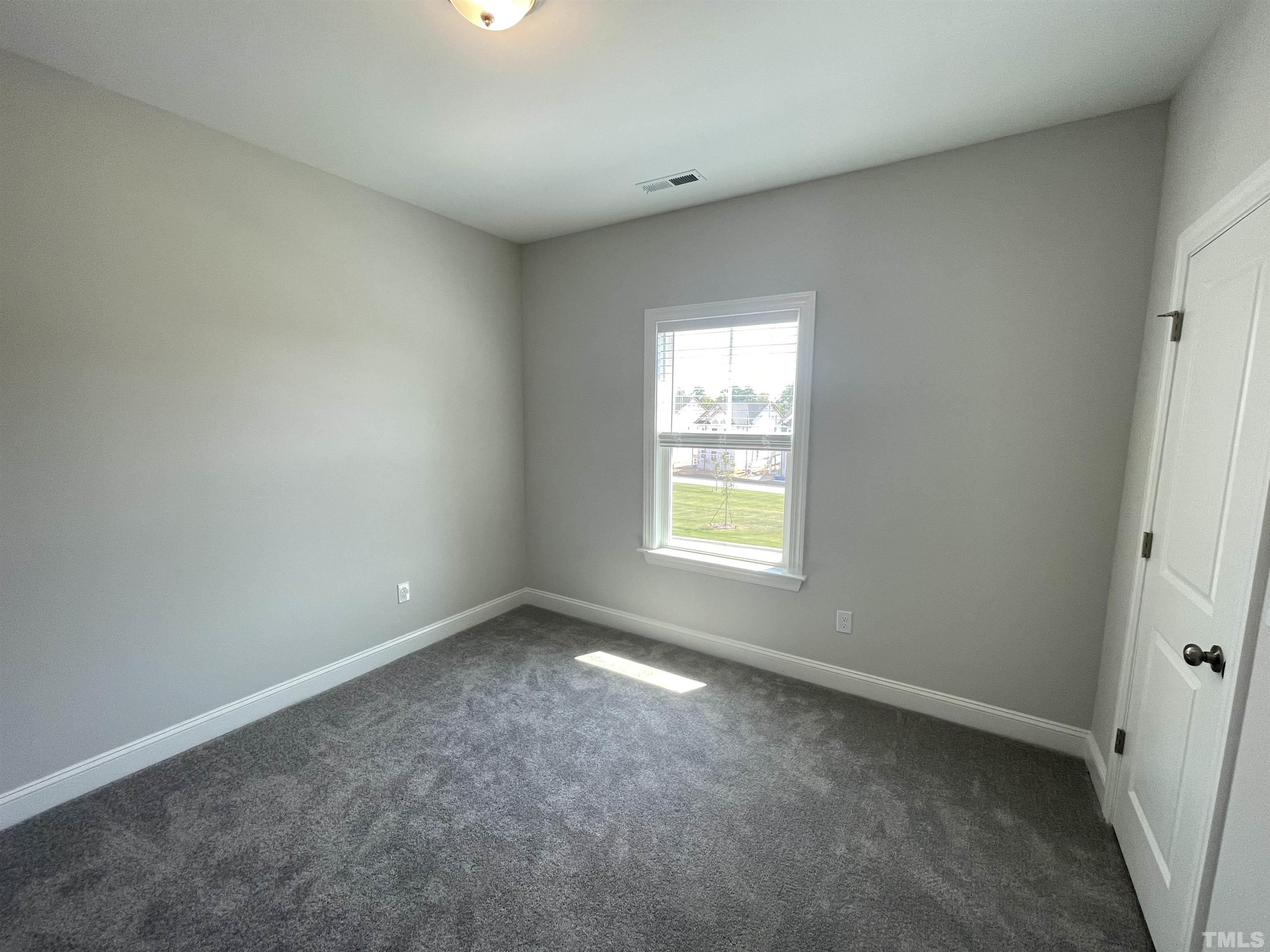 167 Edge Of Auburn Boulevard Clayton, NC 27520 - Photo 20 of 27 an empty room with a window