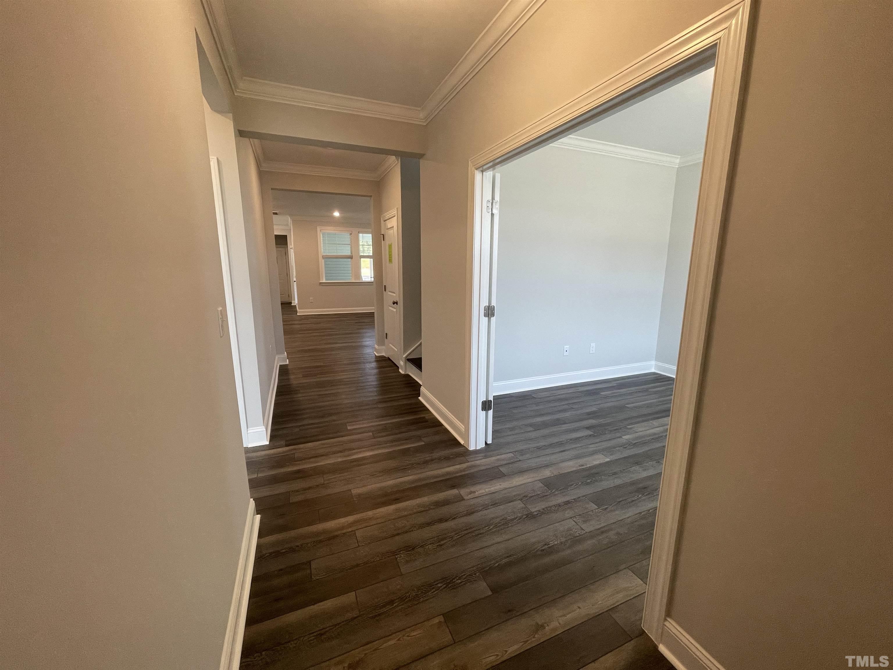 167 Edge Of Auburn Boulevard Clayton, NC 27520 - Photo 2 of 27 a view of a hallway with wooden floor and a bathroom