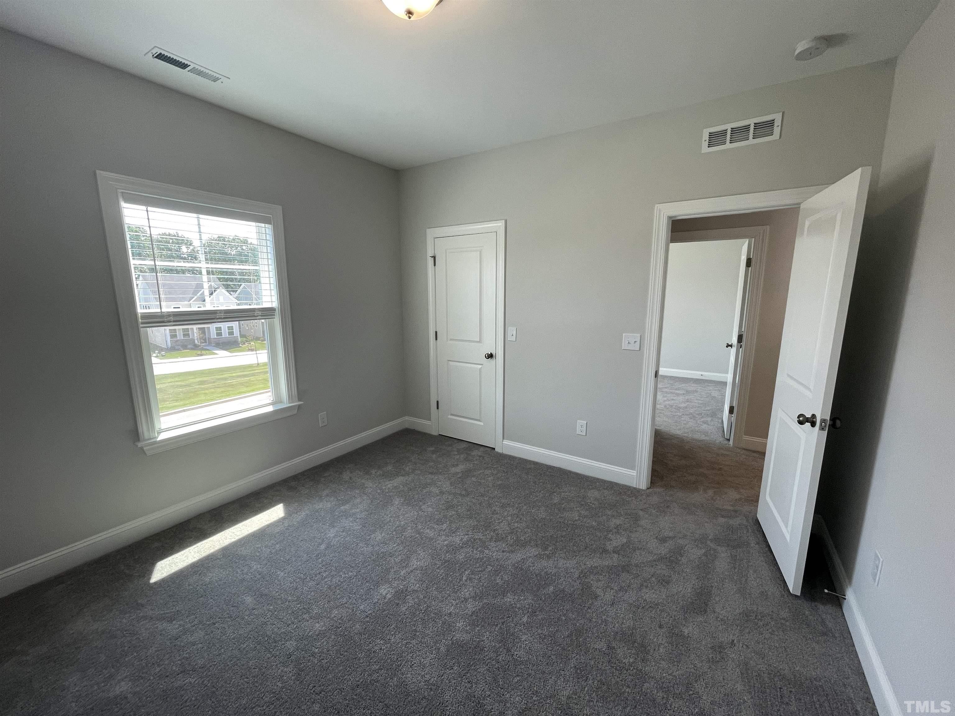 167 Edge Of Auburn Boulevard Clayton, NC 27520 - Photo 21 of 27 an empty room with windows