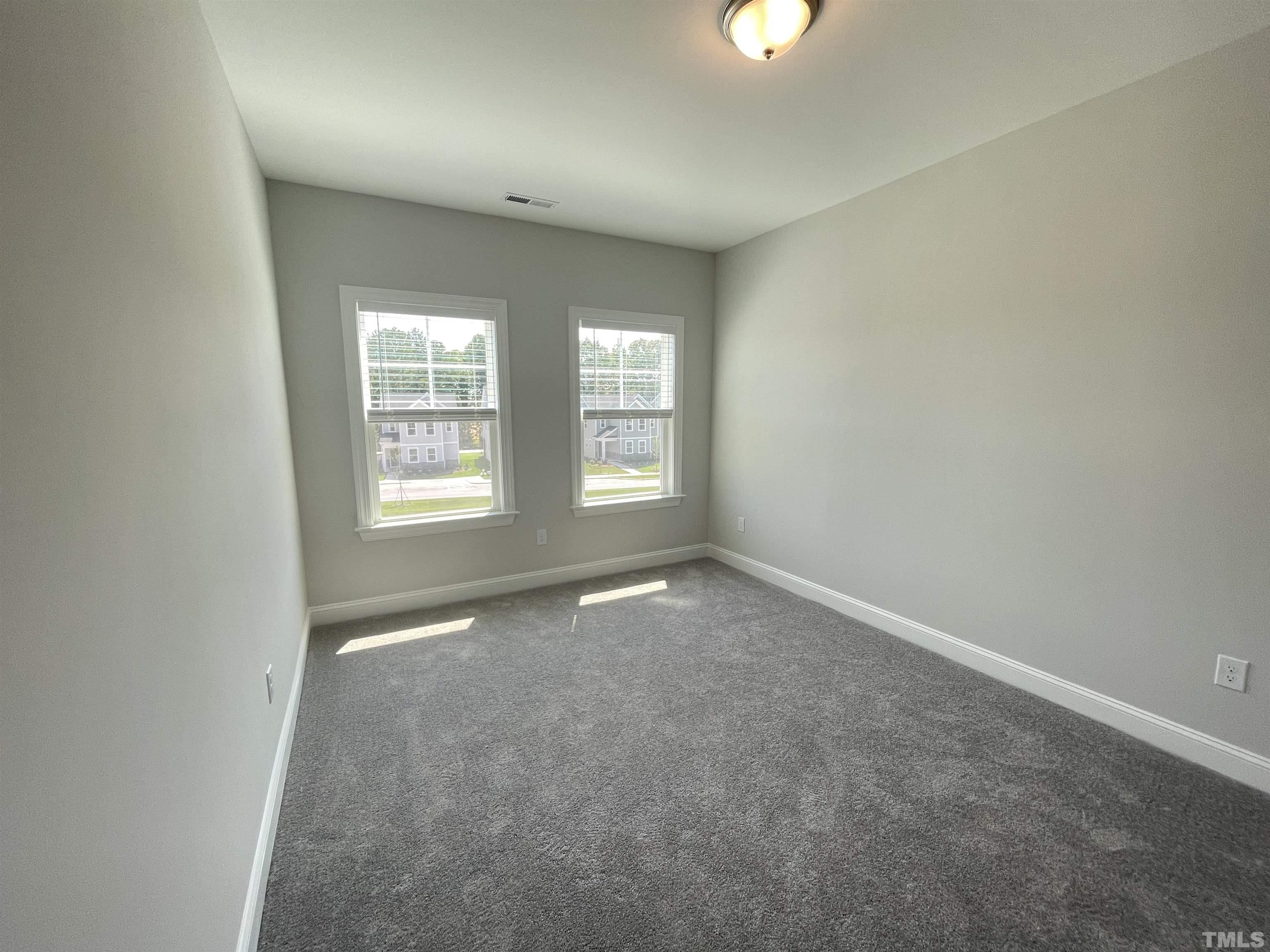 167 Edge Of Auburn Boulevard Clayton, NC 27520 - Photo 23 of 27 an empty room with windows and closet