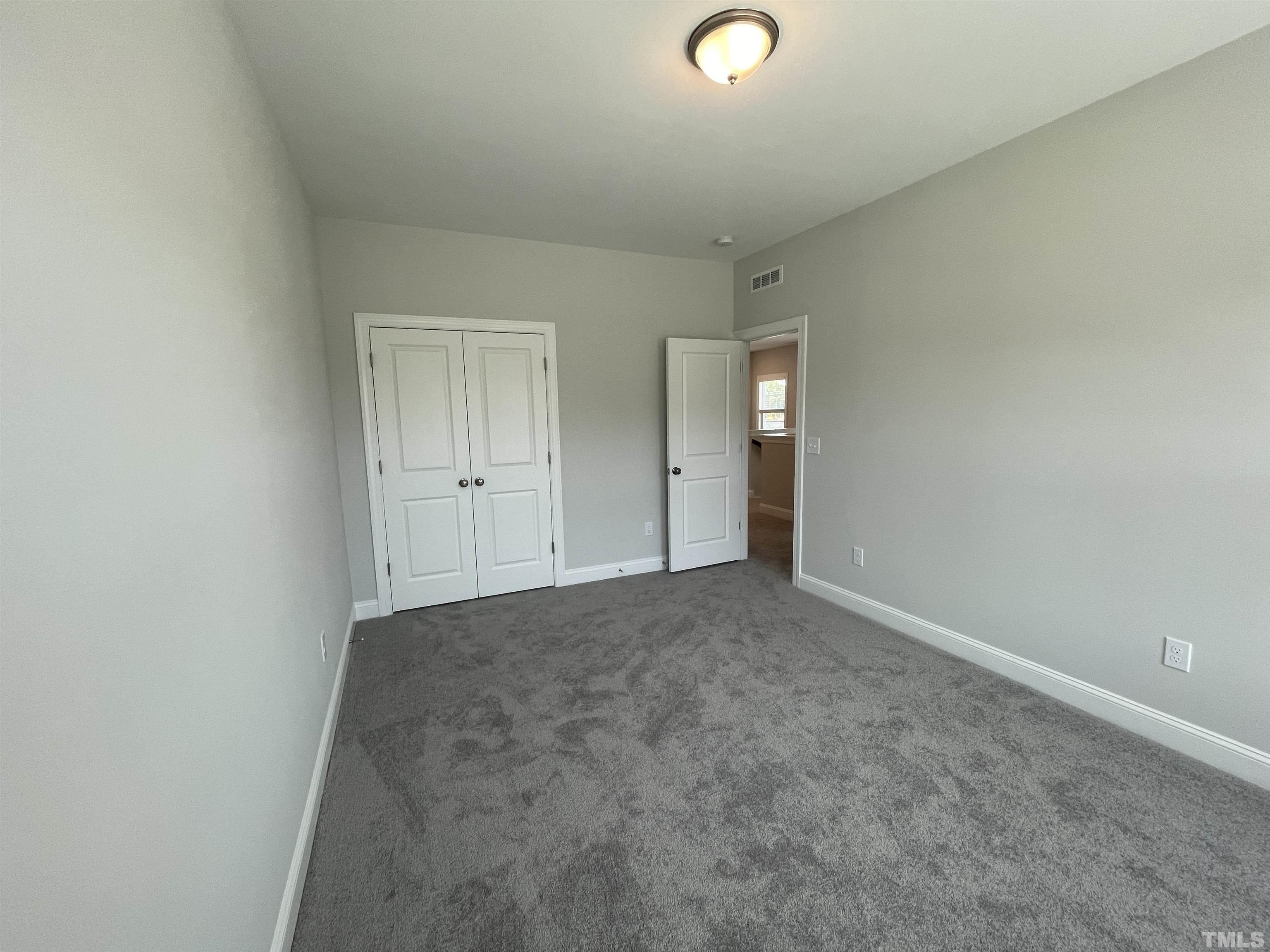 167 Edge Of Auburn Boulevard Clayton, NC 27520 - Photo 24 of 27 an empty room with an entryway