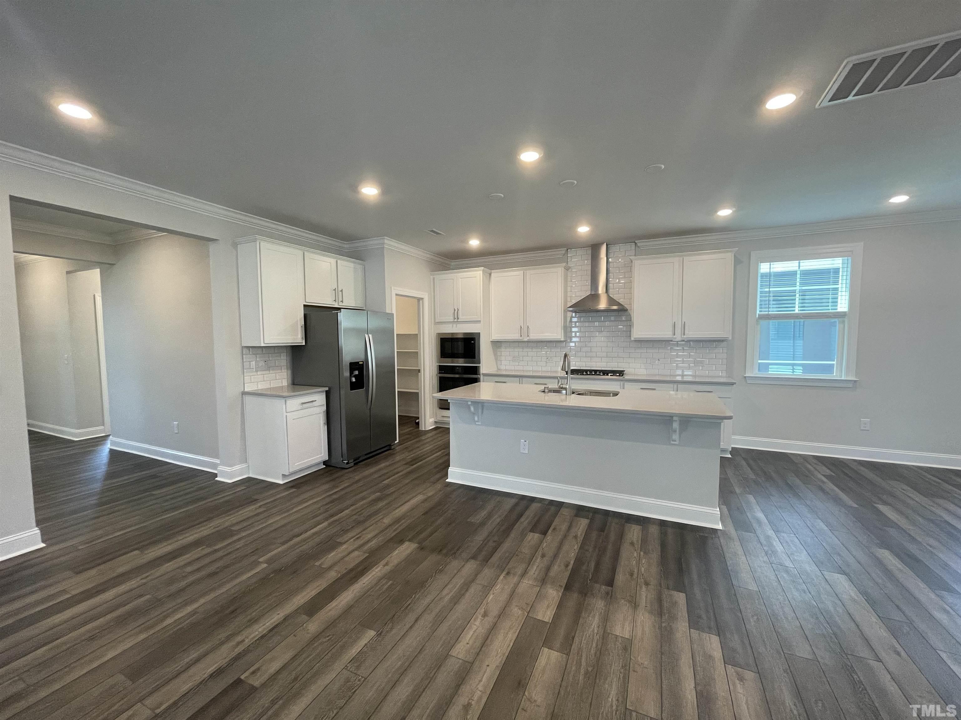 167 Edge Of Auburn Boulevard Clayton, NC 27520 - Photo 7 of 27 a large kitchen with stainless steel appliances refrigerator sink and cabinets