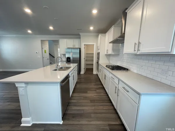 a large kitchen with a stove and a sink