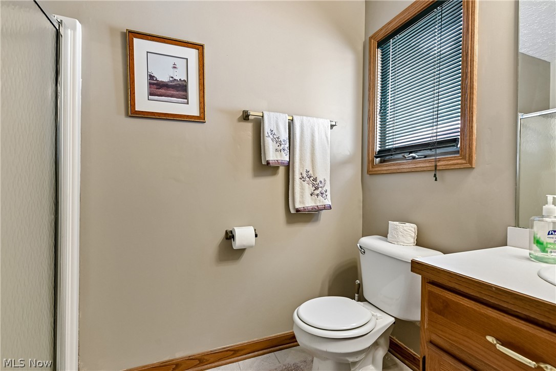 2660 South Medina Line Road Wadsworth, OH 44281 - Photo 17 of 48 First floor full bathroom with shower, sink/vanity, commode and LVT flooring