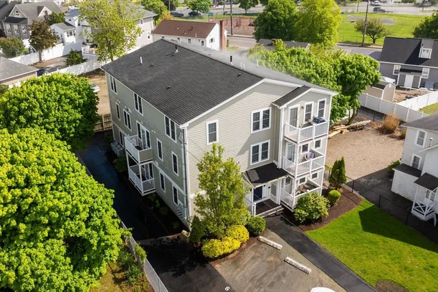 a aerial view of a house next to a yard