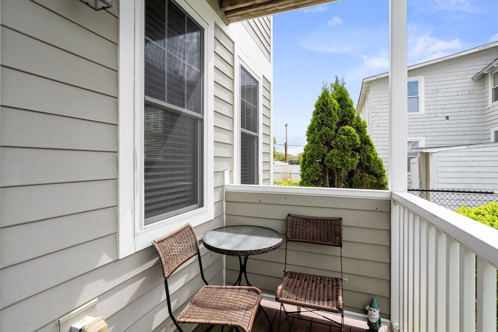 10 Malta Street, Unit 1 Hull, MA 02045 - Photo 3 of 17 a view of balcony with a table and chairs and wooden fence