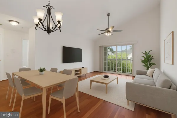 a living room with furniture a chandelier and a flat screen tv