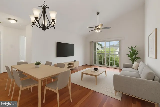 a living room with furniture a chandelier and a flat screen tv
