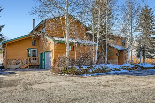 a view of a house with snow on the road
