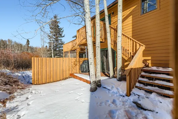 a view of a house with a wooden deck